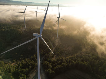 Aerial view of windfarm at foggy sunset