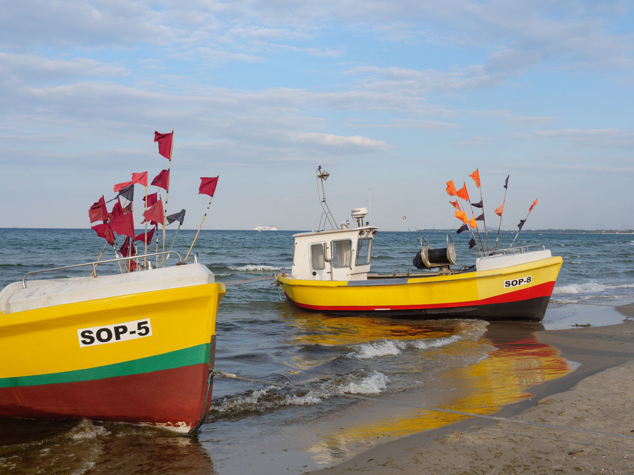 VIEW OF BOATS MOORED ON BEACH AGAINST SKY