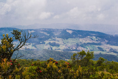 Scenic view of mountains against cloudy sky