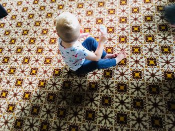 High angle view of child on floor