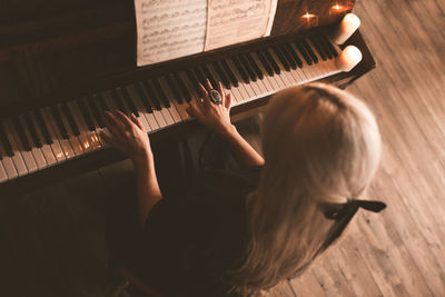 High angle view of woman playing piano