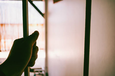 Close-up of hand on window