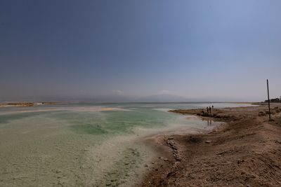 Scenic view of beach against clear sky