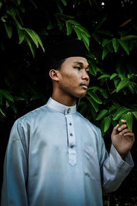 Young man wearing plant