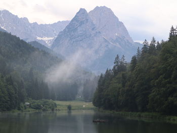 Scenic view of lake and mountains against sky