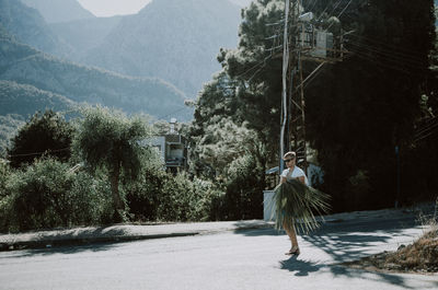 Rear view of man walking on road