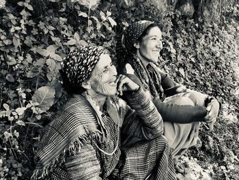 Rear view of couple sitting outdoors