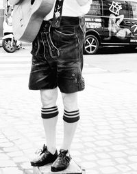 Low section of man standing on footpath