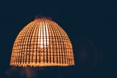 Close-up of hanging light over black background