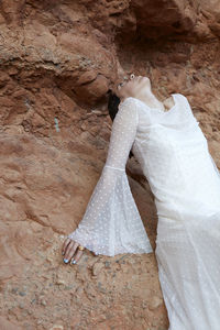 Low section of bride standing in cave