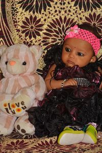 Portrait of cute girl with toy toys at home