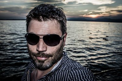 Portrait of man wearing sunglasses in sea