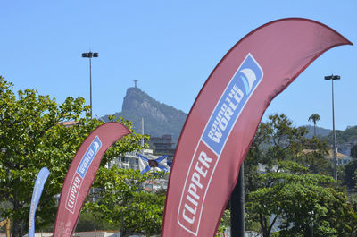 Low angle view of sign board against blue sky