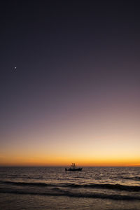 Scenic view of sea against clear sky during sunset