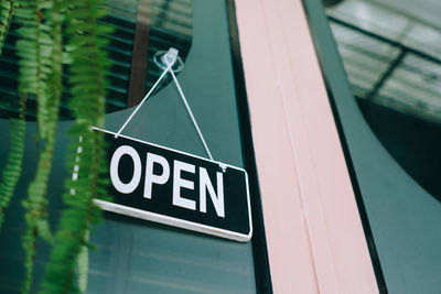 Low angle view of sign on glass