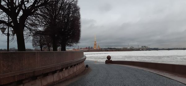 View of buildings in city against cloudy sky