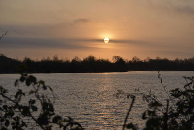 Scenic view of lake against sky during sunset