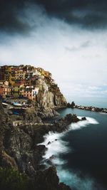 Scenic view of sea by cliff against sky