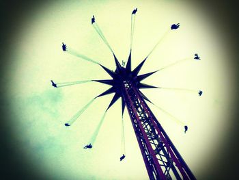 Low angle view of ferris wheel against sky