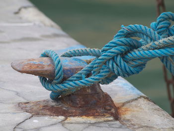 Close-up of rope tied on bollard