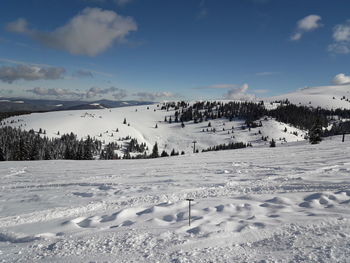 Scenic view of snow covered landscape against sky