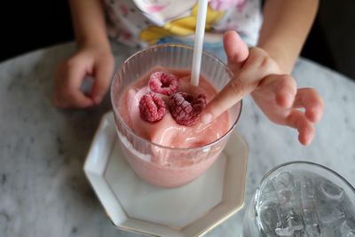 Midsection of child having dessert at table