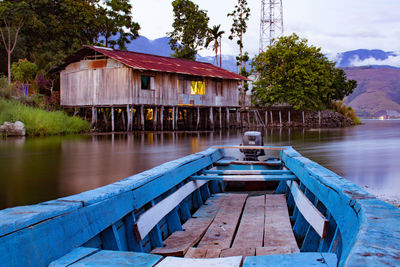 Built structure by lake against building