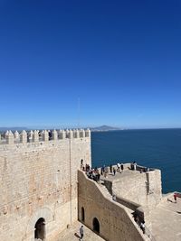 Scenic view of sea against clear blue sky