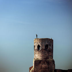 Low angle view of abandoned building against clear sky