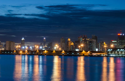 Illuminated buildings in city at waterfront