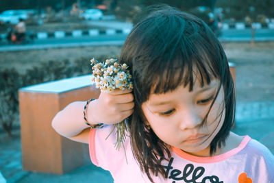 Portrait of girl holding swimming pool