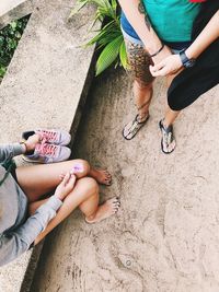 Low section of women sitting outdoors