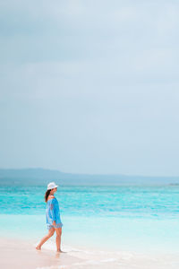 Side view of woman walking on beach