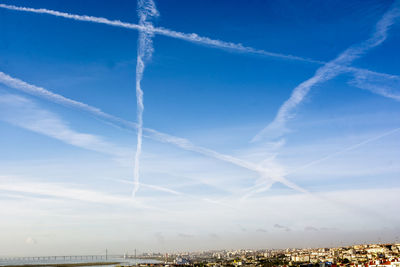 Low angle view of vapor trail against blue sky