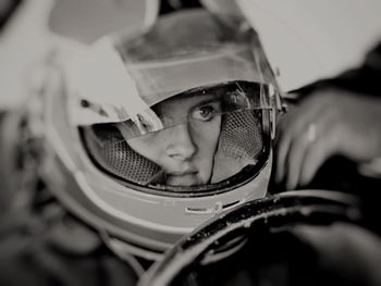 Close-up of girl sitting in racing car