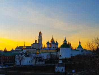 View of buildings in city at sunset