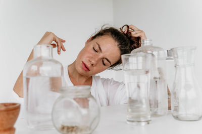 Portrait of young woman drinking glass