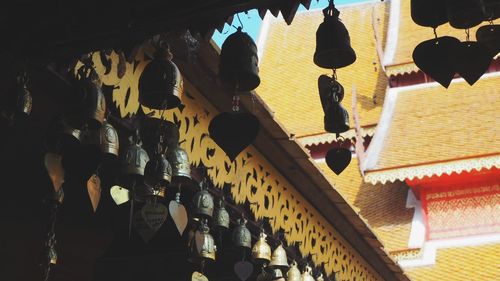 Low angle view of illuminated lanterns hanging on ceiling of building