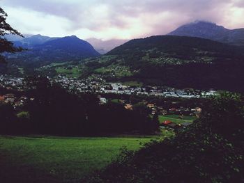 Scenic view of field and mountains against sky