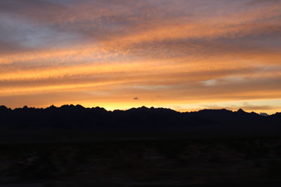 Scenic view of silhouette landscape against romantic sky at sunset