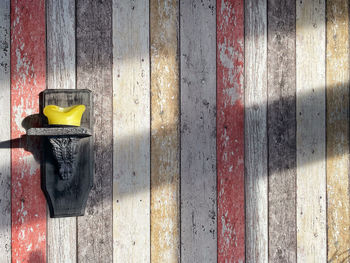 Close-up of metallic structure on wooden wall