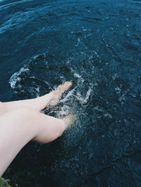 Woman moving legs in water