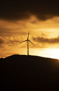 Spain, andalusia, tarifa, wind wheels on mountain at sunrise