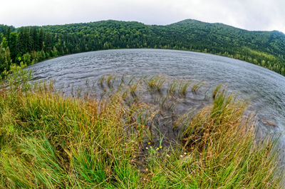 Scenic view of waterfall against sky