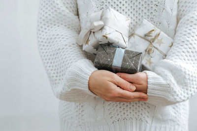 Midsection of woman holding gift boxes