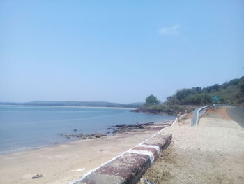 View of calm beach against clear sky