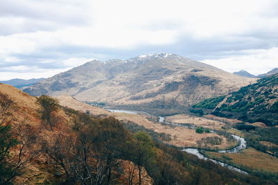 Scenic view of mountains against cloudy sky