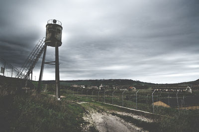 Built structure on field against sky