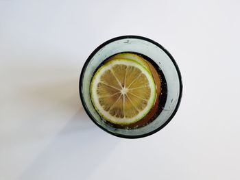 Directly above shot of drink in glass against white background