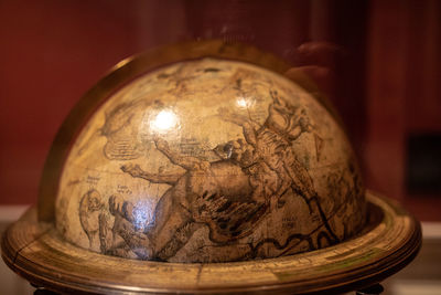 Close-up of illuminated lamp on table